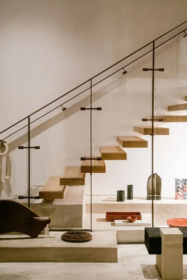 Escalier suspendu en bois et garde-corps en verre chez Ogata Paris, photographie d'architecture intérieure dans le Marais