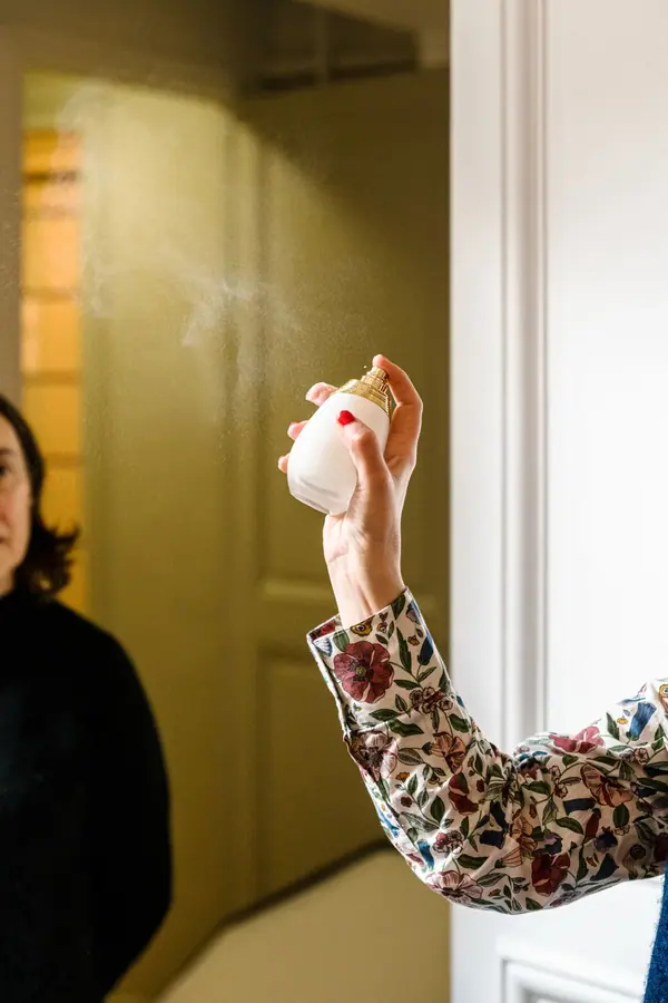 Main vaporisant un parfum lors de la séance de réflexion Cosmétique Mag et Takasago, reportage photo en lumière naturelle